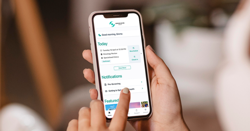 Image o a phone screen with a womans finger interacting with an app on the screen