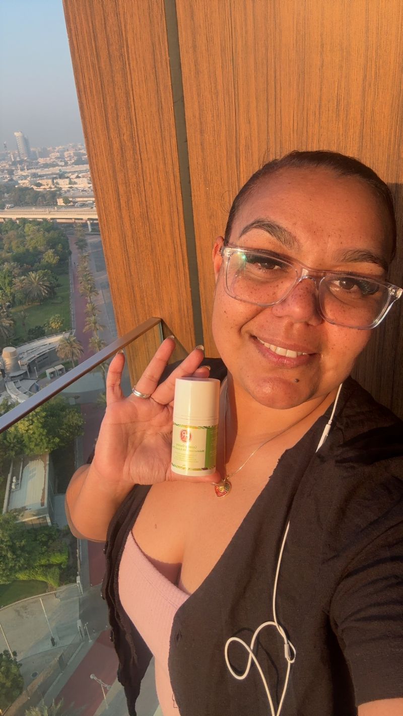Photo of Helen Rose, founder of Helen Rose Pty Ltd and proud First Nations woman, holding one of her natural wellness products made with native Australian botanicals.