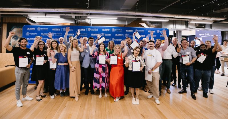 Graduates from the Ignite+ Commercialisation and Growth program standing together, celebrating their achievements in innovation and business growth